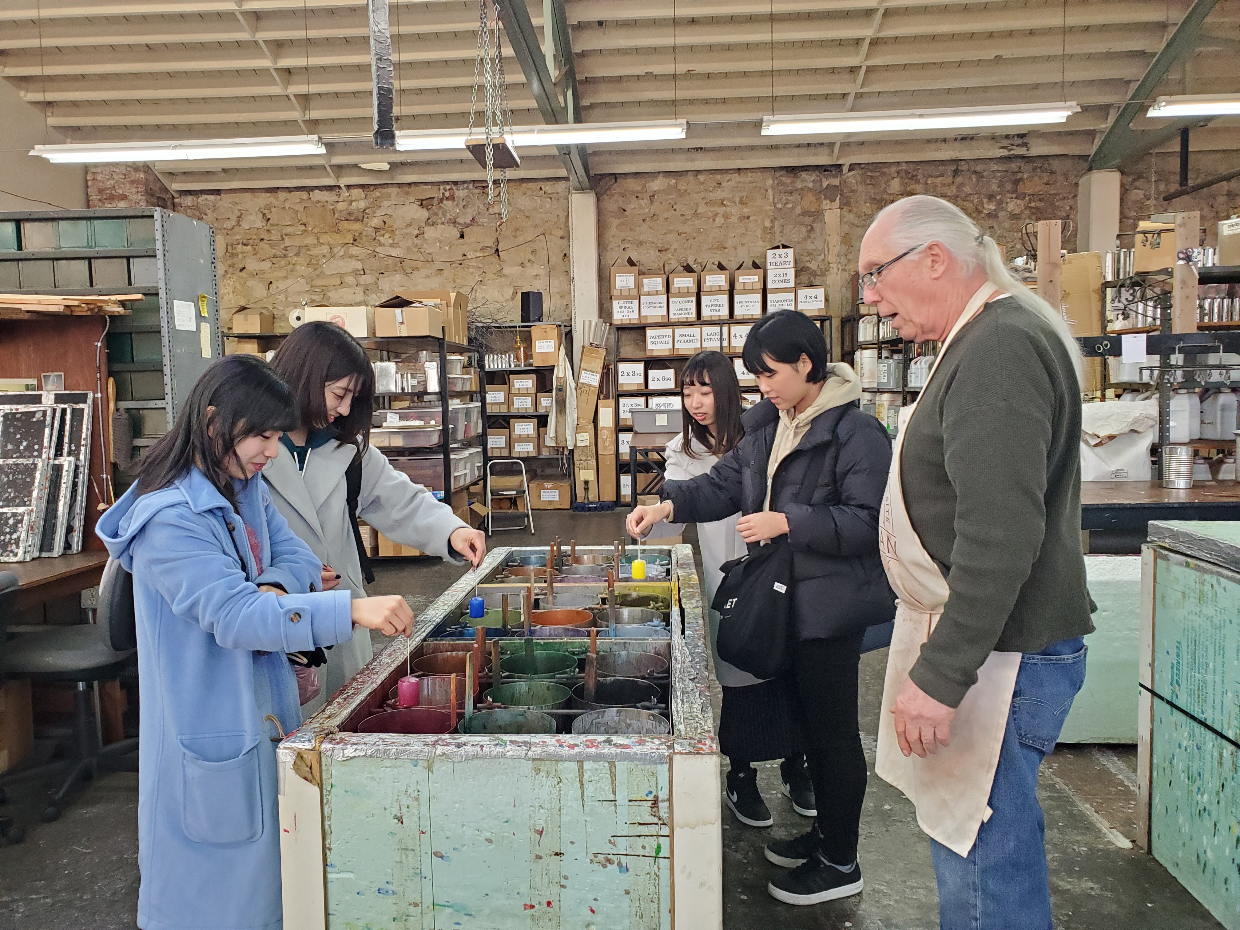 Kanagawa University students touring a local business