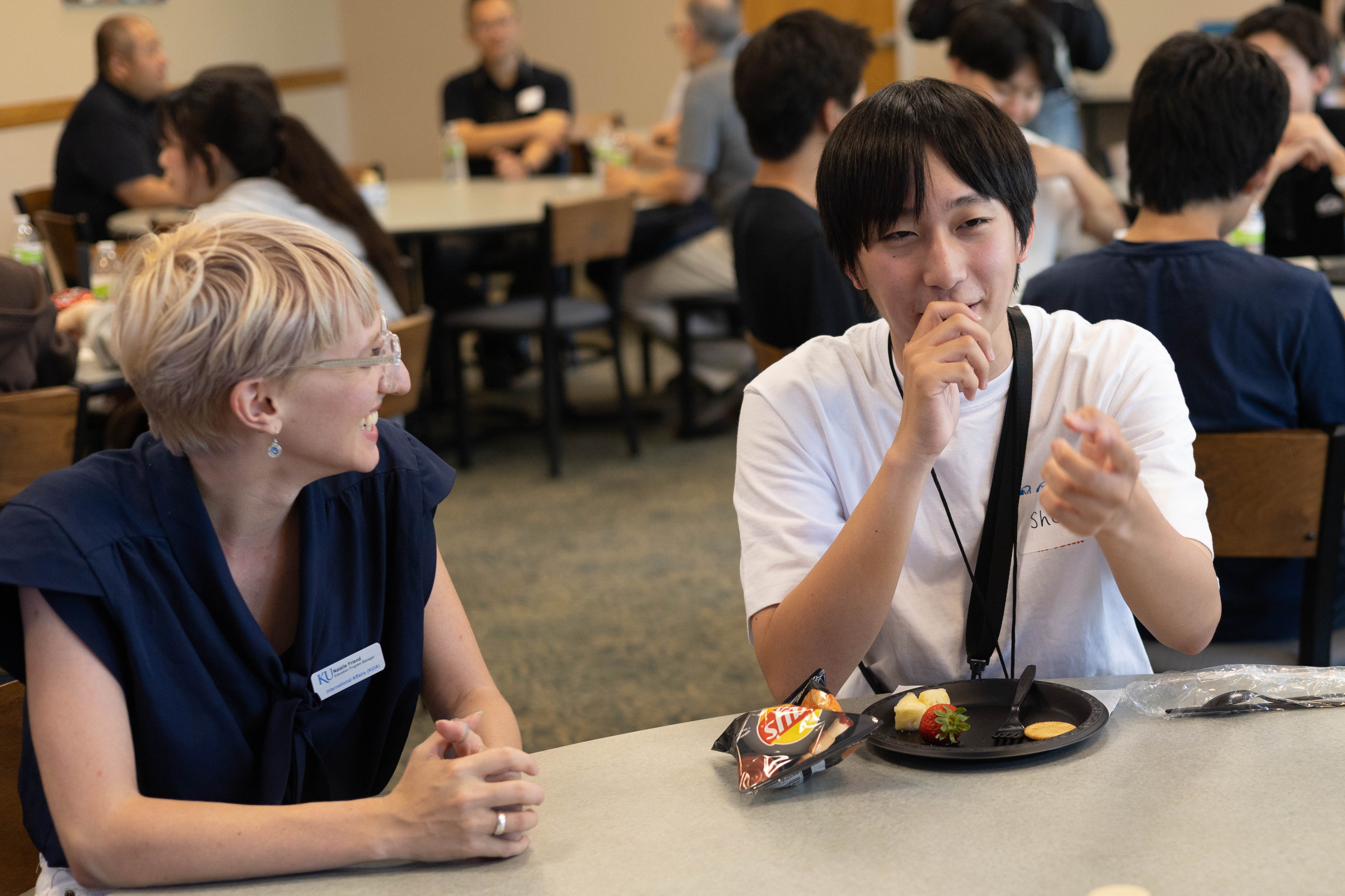 ISP staff at a reception with high school students